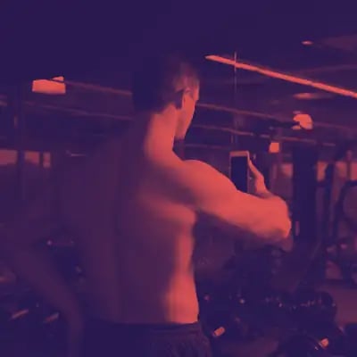 Man taking selfie at gym; red overlay